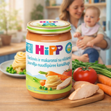 Hipp baby food jar on a table with a family in the background