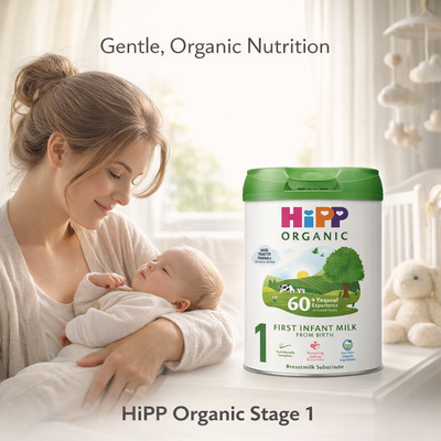 Woman holding a baby with HiPP Organic Stage 1 infant milk powder container in the foreground.