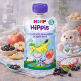 Hippis baby food pouch with dragon and fruit design on a table with fruits and a teddy bear.