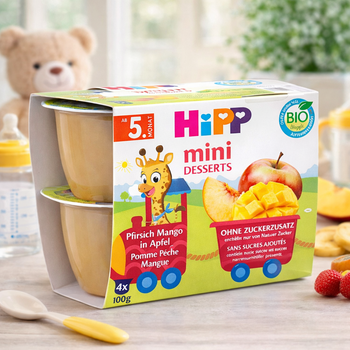 Hipp mini desserts packaging with a teddy bear and fruit in the background