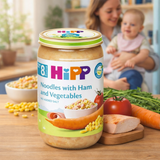 Hipp baby food jar with a family in the background