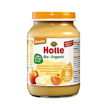 Jar of Holle organic baby food with apple, banana, and apricot on a white background