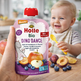 Holle organic baby food packaging with a child and fruits in the background