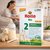 Holle Bio milk packaging with a blurred background of a woman and child, a bottle, and a toy goat.