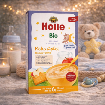 Holle baby food packaging with a teddy bear and baby items in the background
