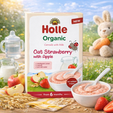 Holle Organic cereal packaging with a bowl of cereal, strawberries, and a bunny toy in a natural setting.
