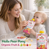 Woman and baby with Holle Pear Pony organic fruit pouches in a home setting