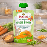 Holle organic baby food pouch on a wooden table with vegetables