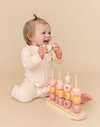 Kit & Petal Long Sleeve Romper in Rosy Peach