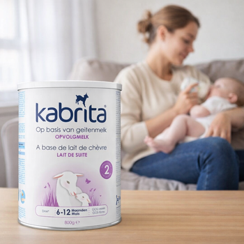 Kabrita baby formula can with a blurred background of a woman holding a baby