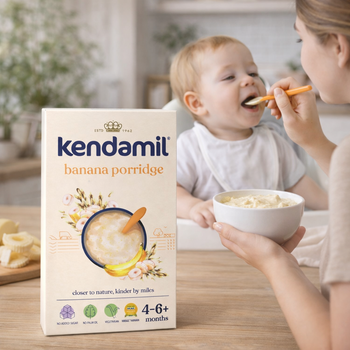 Kendamil banana porridge box with a baby being fed by a woman