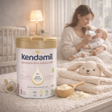 Kendamil premium first infant milk powder with a mother and baby in the background
